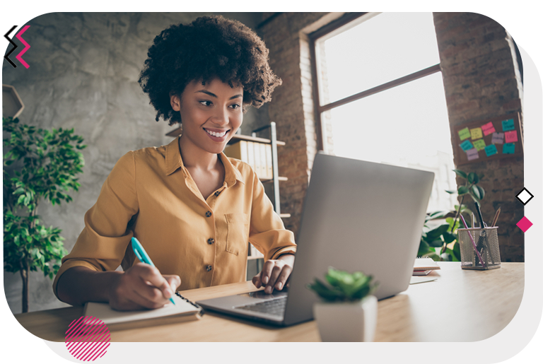 Woman smiling while working on her laptop.