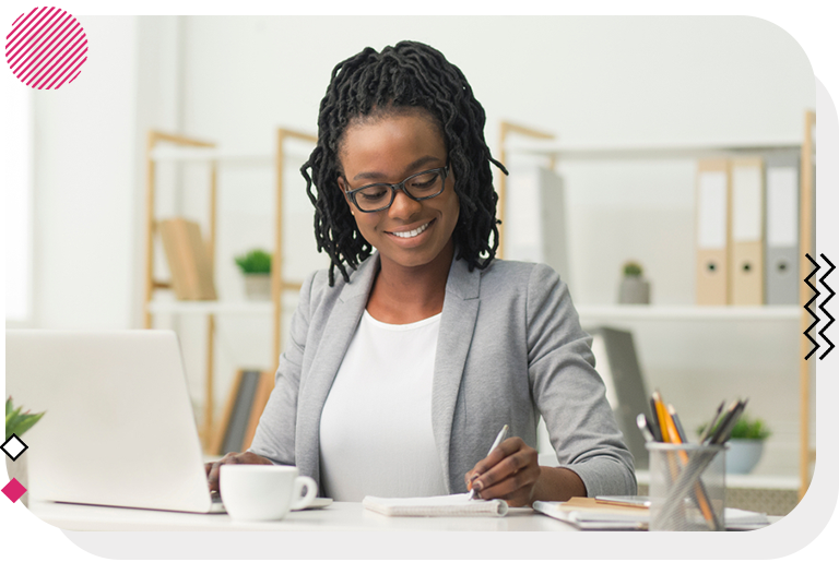 Woman smiling at her work desk.