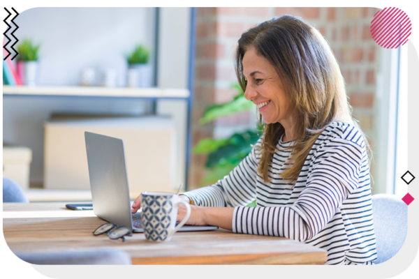 Woman smiling at her laptop.