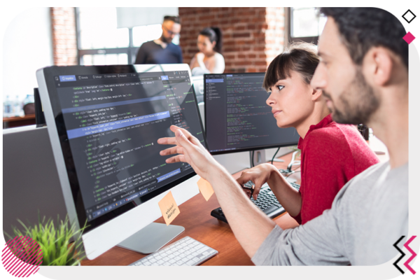 Two colleagues reviewing code on the computer