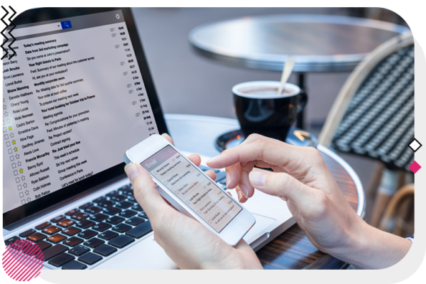 checking emails on laptop and mobile