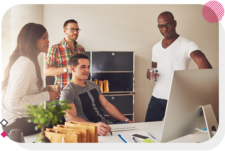 Group looking at computer in office