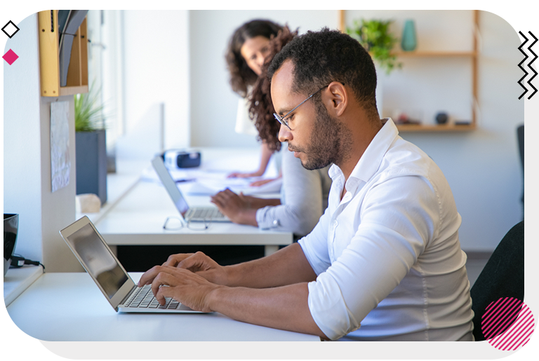 Man typing on laptop in office