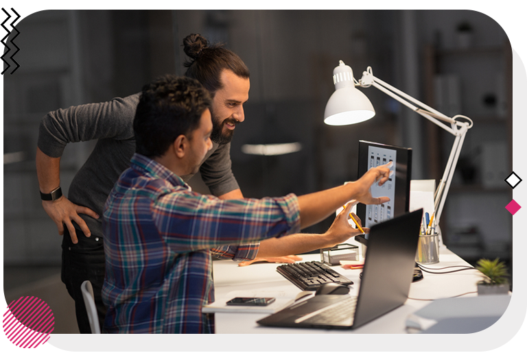 Two designers working on monitor