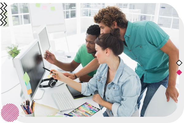 Team of designers looking at computer