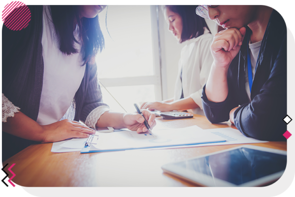 Group of people at a table taking notes