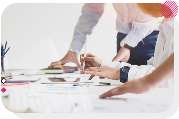 Hands of three people moving and working at a desk