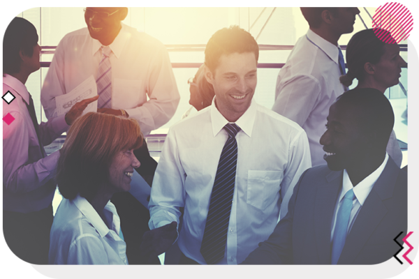 Group of professionally dressed men and women smiling and talking