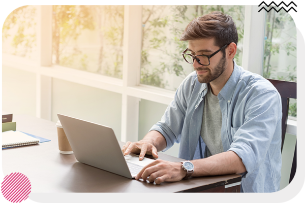 Man at table looking at laptop