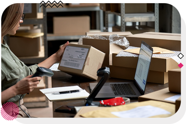 Person scanning a package at a table with a bunch of other packages on it