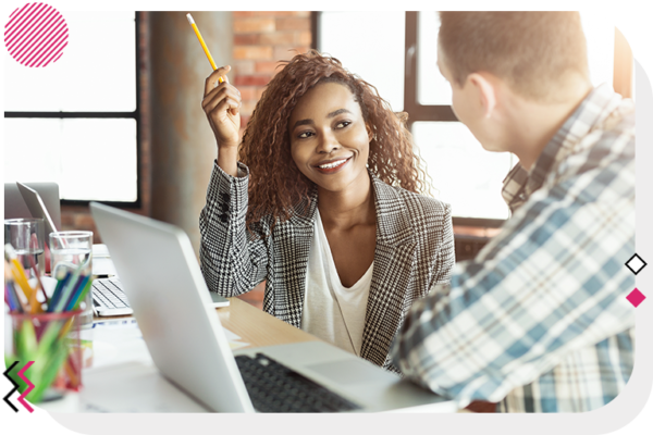 Man and woman smiling at each other at a desk