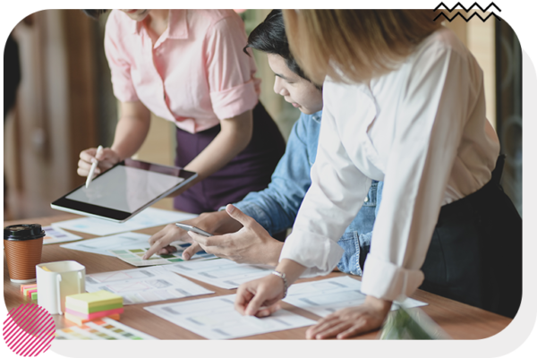 Group of people looking at notes on a desk