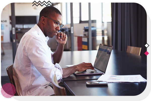 Man sitting at a desk and using a laptop