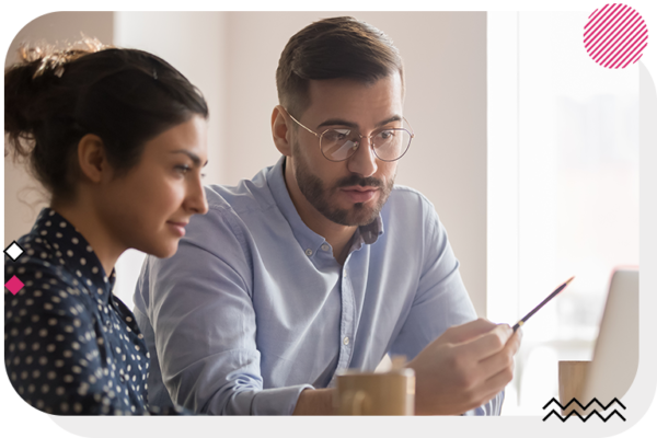 Man and woman sitting down and looking at a laptop